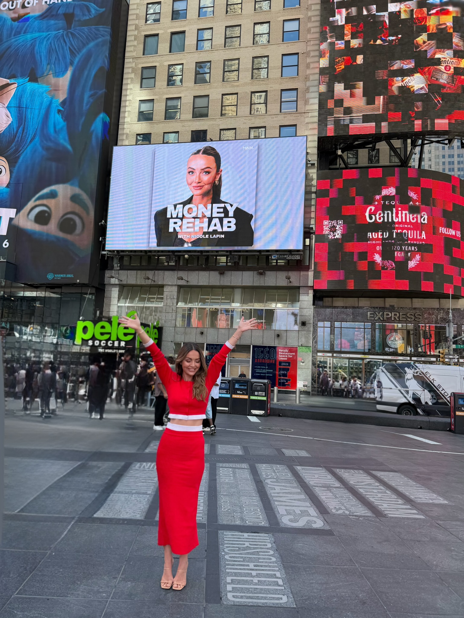 Nicole Lapin in Times Square with the Money Rehab billboard