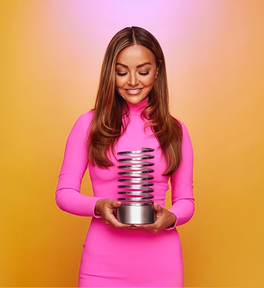 Nicole Lapin holding the Webby Award for Money Rehab