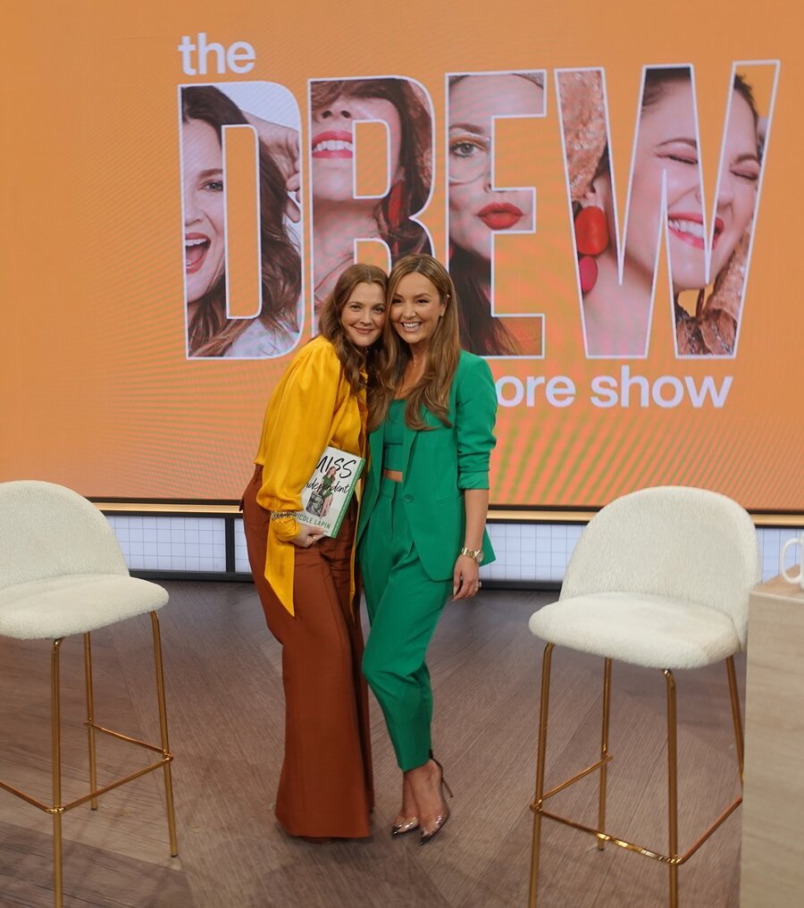 Nicole Lapin with Drew Barrymore holding Miss Independent on The Drew Barrymore Show