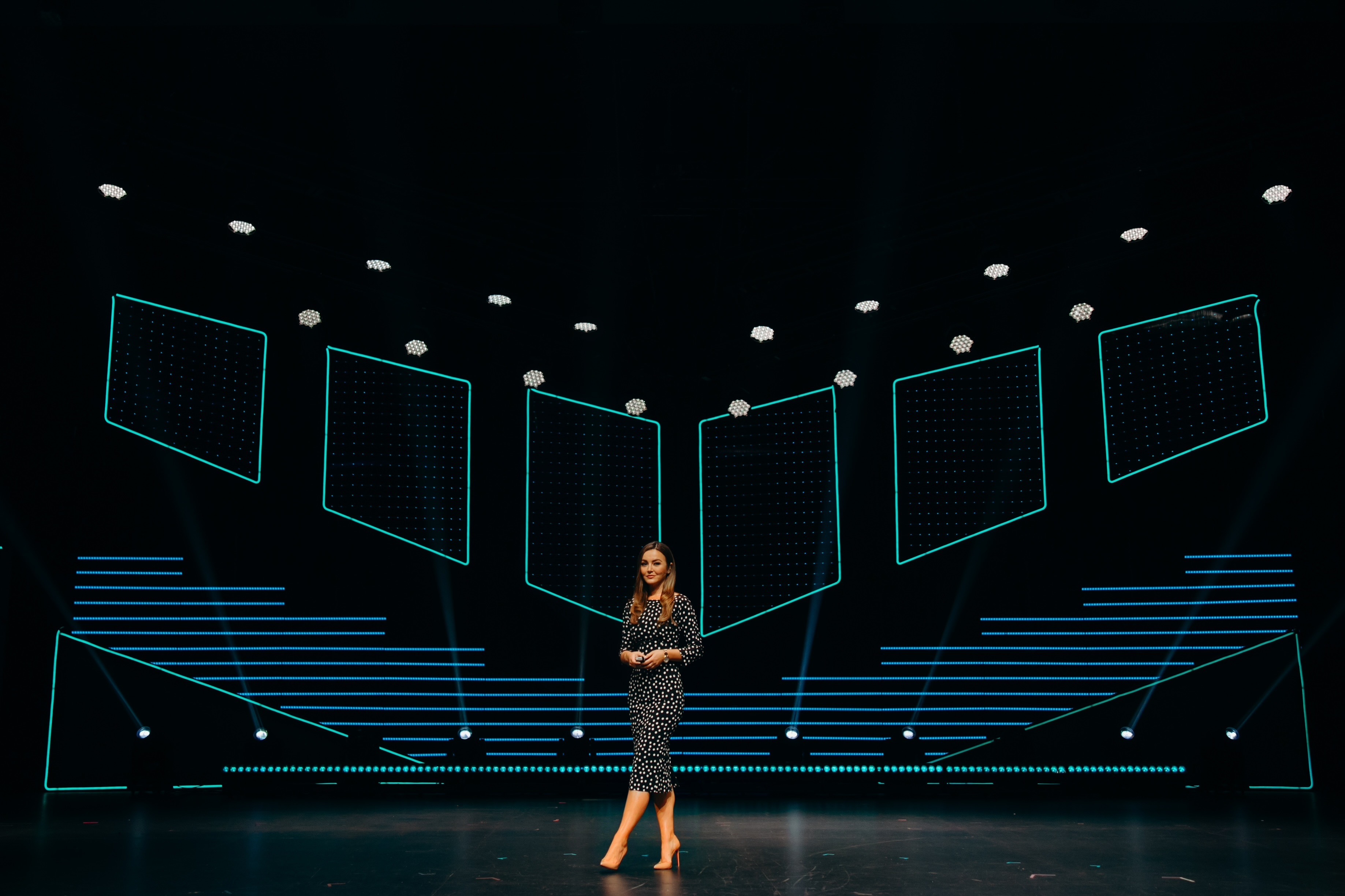 Nicole Lapin delivering a keynote on a large stage