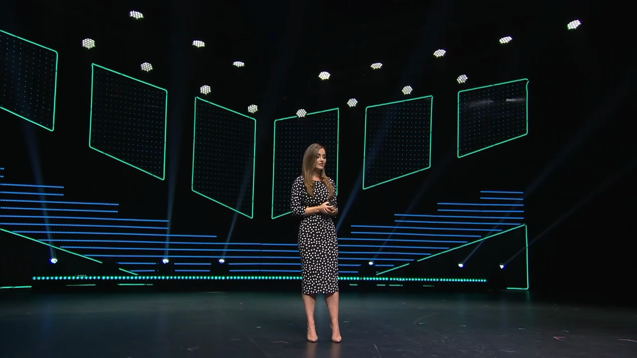 Nicole Lapin speaking on a large conference stage